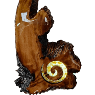 A Kauri root slice with a lit up amber koru.